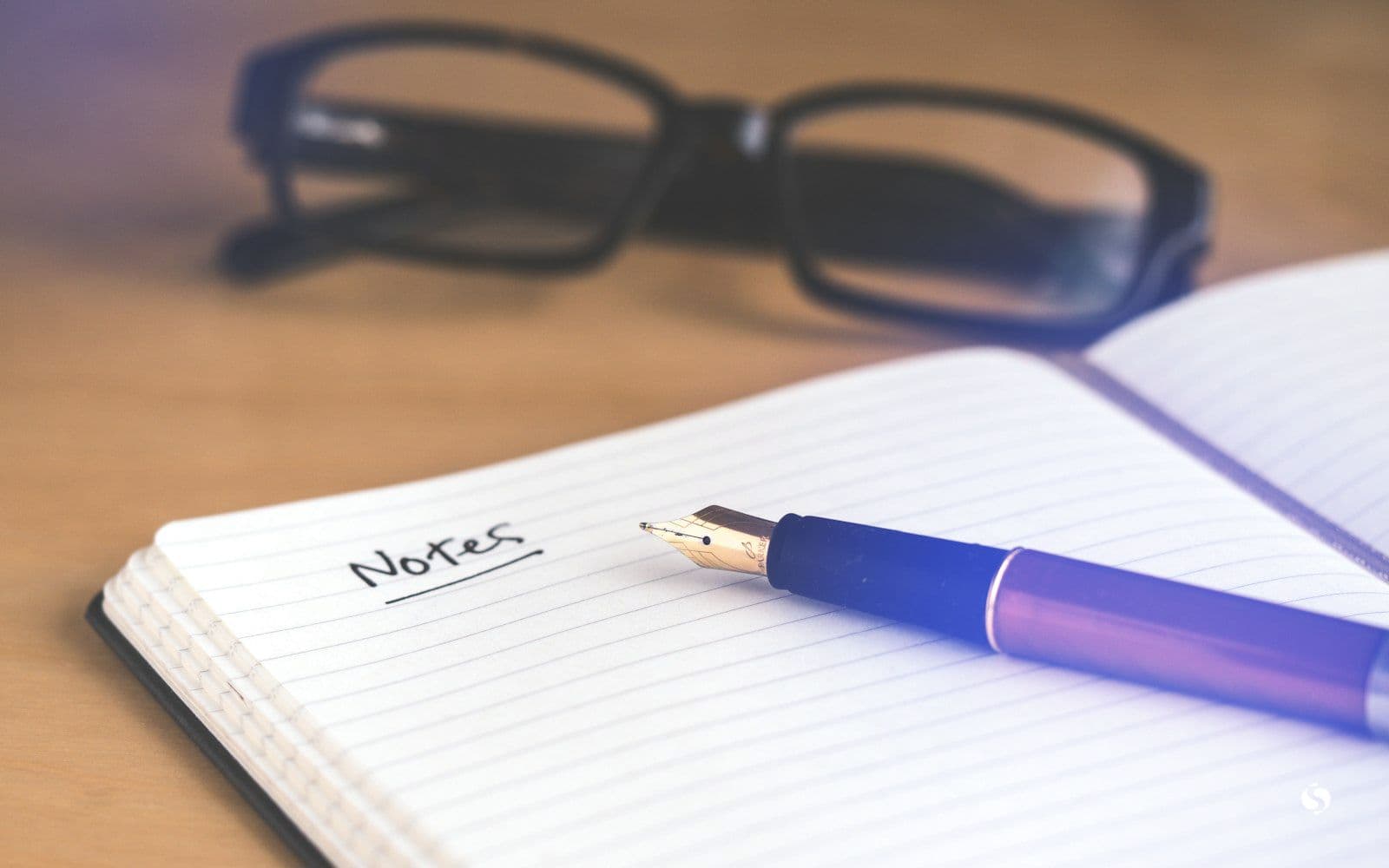 A fountain pen on an open notebook