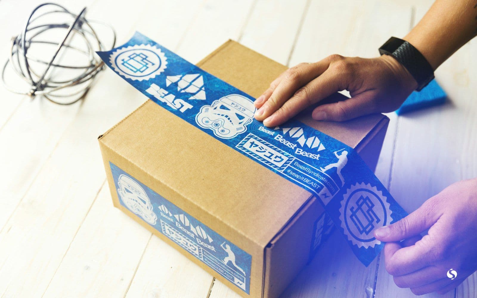 Hands taping up a parcel box