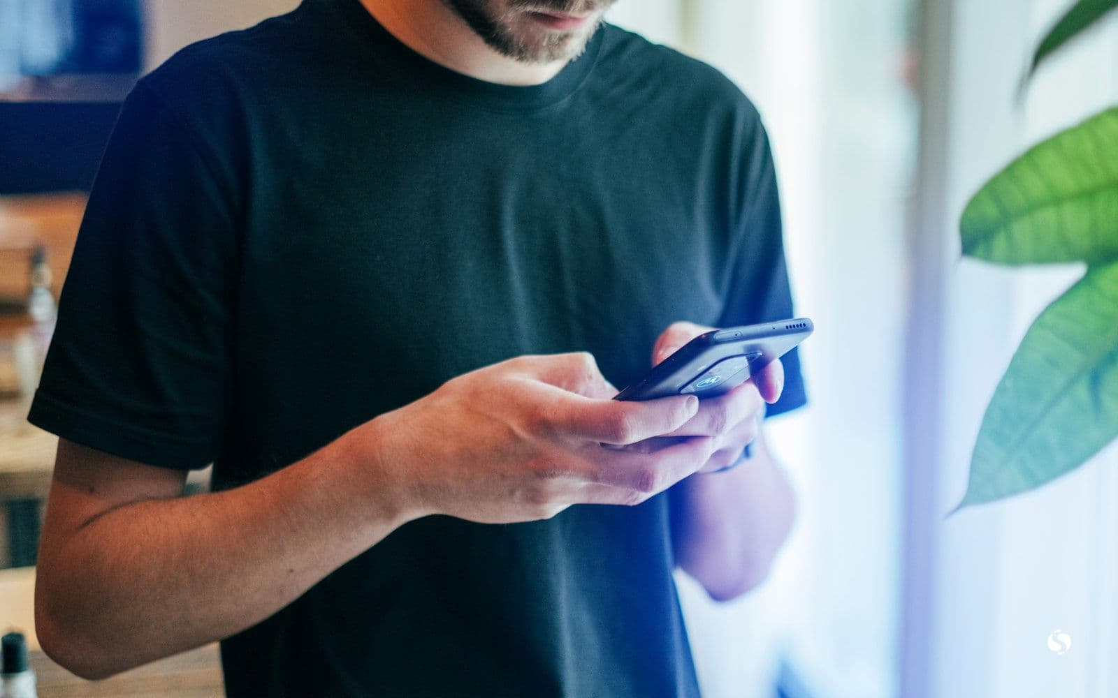 A man scrolling on his phone