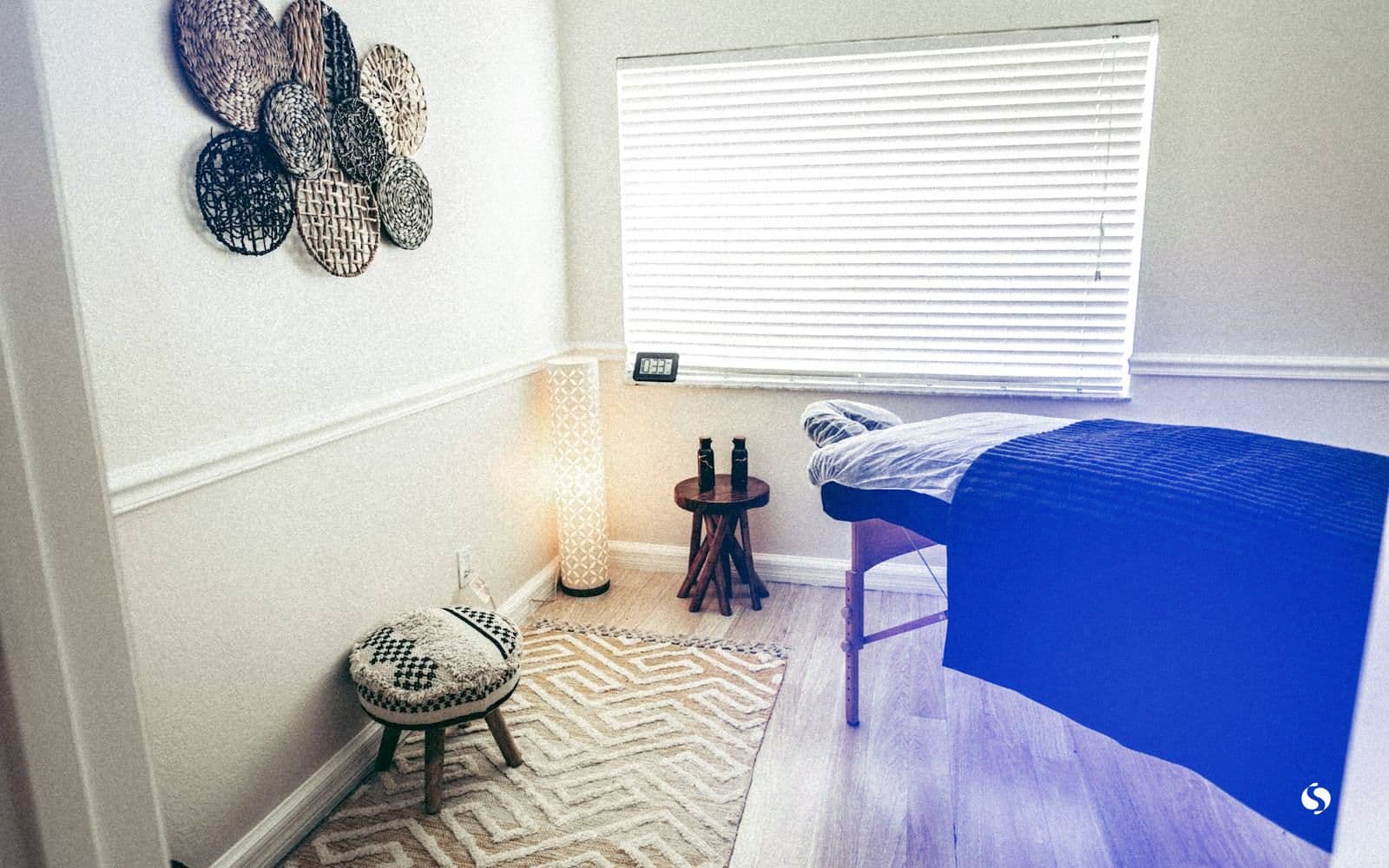 A treatment room with the massage bed ready